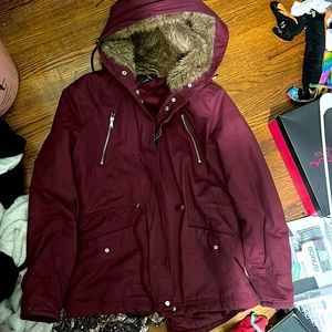 Big red winter jacket with brown fur hood. Size: Medium